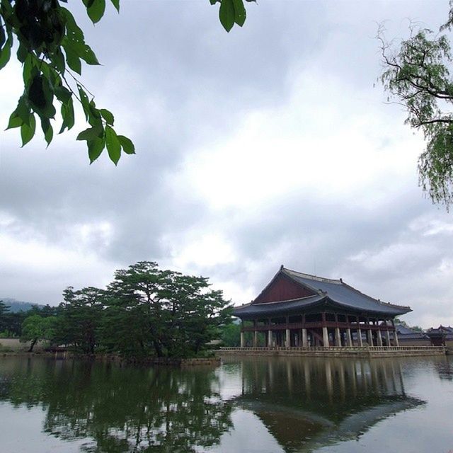 architecture, built structure, water, building exterior, tree, sky, reflection, waterfront, cloud - sky, lake, house, cloud, cloudy, day, nature, tranquility, river, gazebo, outdoors, pond