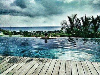 Scenic view of sea against cloudy sky