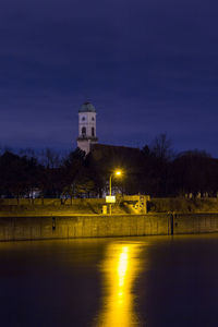 Illuminated building against sky at night