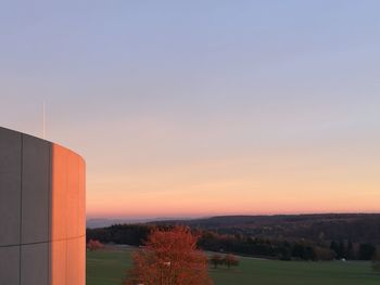 Factory against sky at sunset