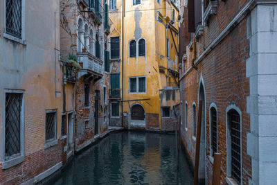 Canal amidst buildings in city