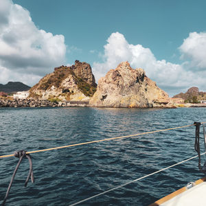 Scenic view of sea and mountains against sky