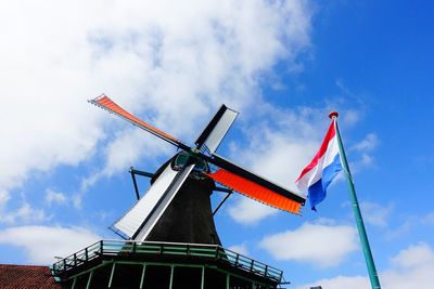 Low angle view of crane against blue sky