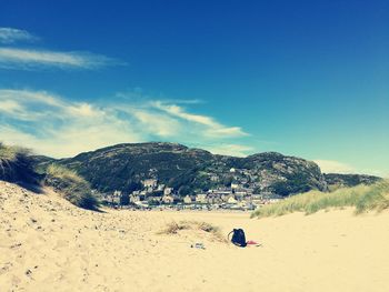 People on beach against blue sky