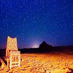 Built structure on land against sky at night