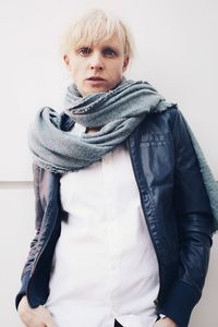 Portrait of teenage girl standing against white background