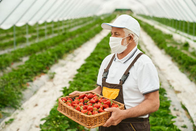 Man working in basket on field