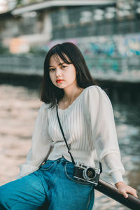 Portrait of a beautiful young woman standing outdoors