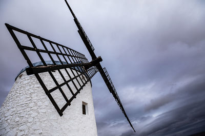 Low angle view of traditional windmill against sky