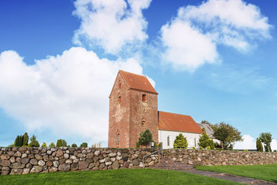 View of old building against cloudy sky