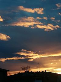 Low angle view of silhouette building against sky during sunset