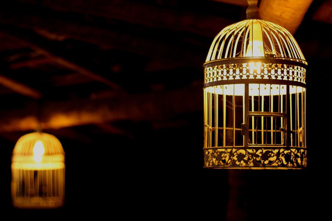 LOW ANGLE VIEW OF ILLUMINATED PENDANT LIGHTS