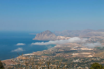 Scenic view of sea and mountains against sky