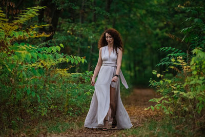 Woman standing in a forest