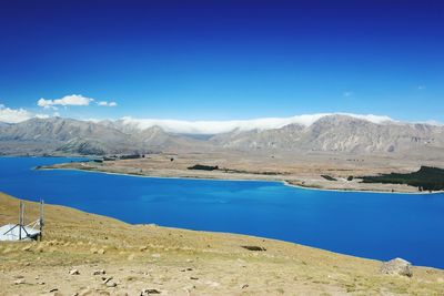 Scenic view of mountains against blue sky