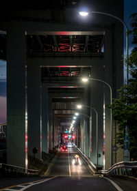 Illuminated underpass in city at dusk