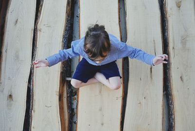 Girl doing yoga on logs