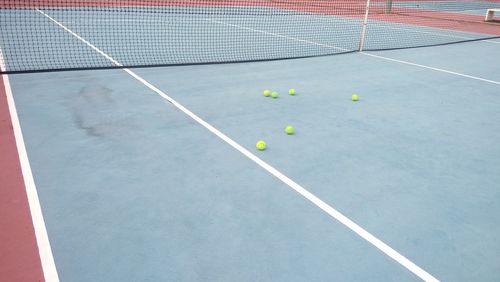 High angle view of tennis balls on sports court