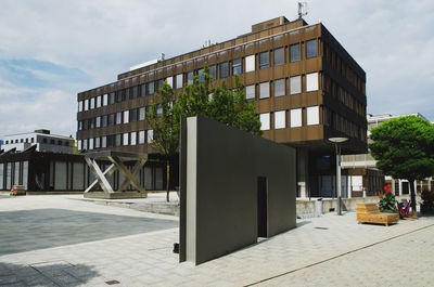 Exterior of building by street against sky