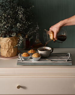 Person holding coffee cup on table