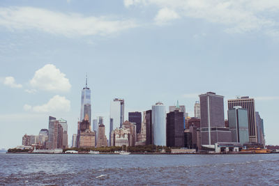 Sea with skyscrapers in background