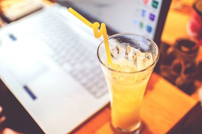 High angle view of drink on table by laptop