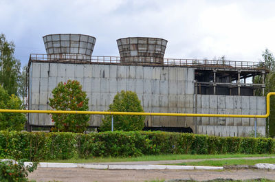 Low angle view of abandoned factory against sky