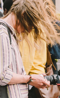 Close-up of woman holding camera