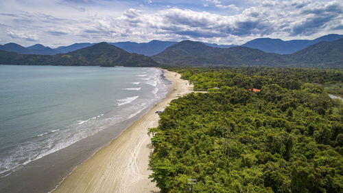 Scenic view of sea and mountains against sky