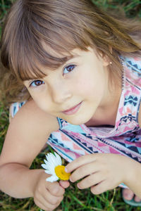 Close-up of girl playing with flowers