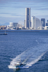 Scenic view of sea and buildings against sky