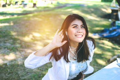 Portrait of smiling young woman standing outdoors