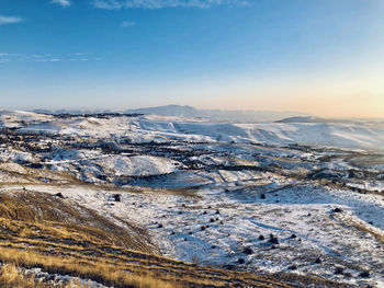 Aerial view of snowcapped mountains against sky