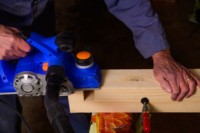 Cropped image of carpenter working in workshop