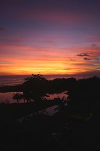 Scenic view of lake against romantic sky at sunset