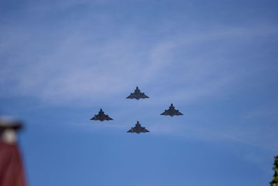 Low angle view of airplanes flying in sky