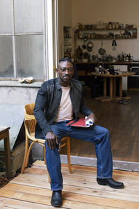 Young man sitting on chair