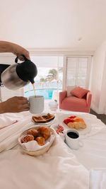 Midsection of man having breakfast at hotel