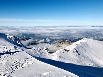 Scenic view of snowcapped mountains against sky