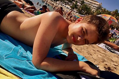 Boy lying on beach
