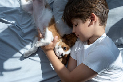 Close-up of child playing with dog. boy with pet. 