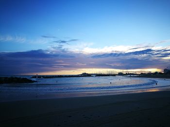 View of calm beach at sunset