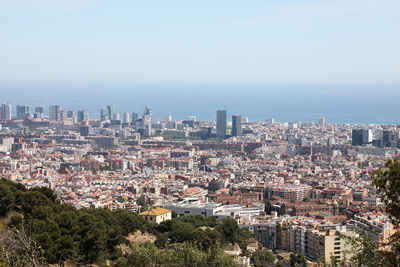 High angle view of buildings in city against clear sky