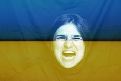 War between russia and ukraine. young woman screaming, hate, rage. crying emotional angry woman 