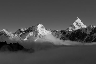 Scenic view of snowcapped mountains against clear sky