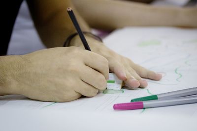 Close-up of hand holding pencils