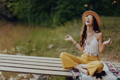 Portrait of young woman sitting on bench