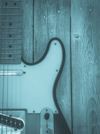 Close-up of guitar against wall