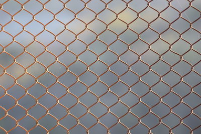 Full frame shot of chainlink fence against sky