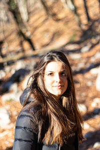 Portrait of beautiful young woman standing outdoors